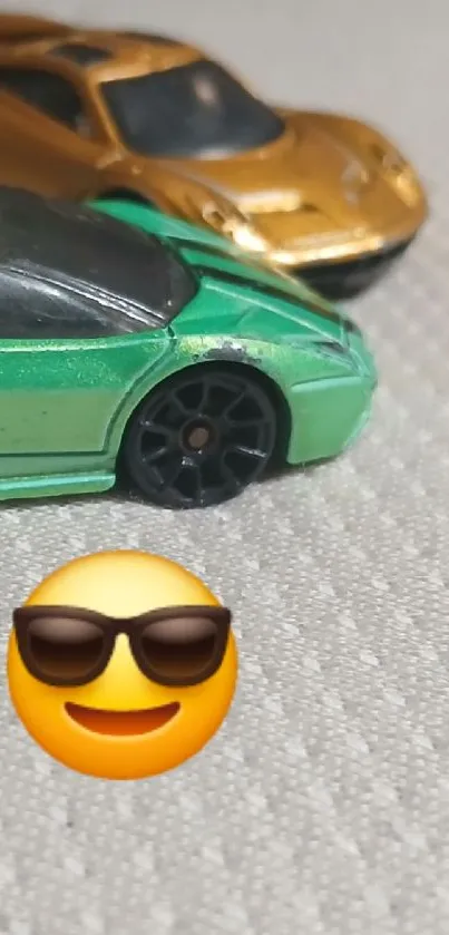 Green and gold toy cars with emoji.