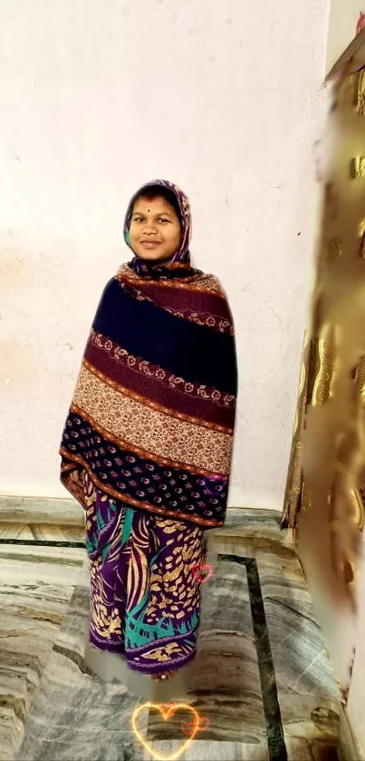 Woman in colorful traditional Indian attire against neutral background.