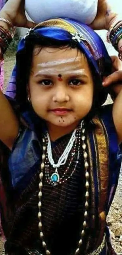 Child in vibrant traditional attire showcasing cultural beauty.