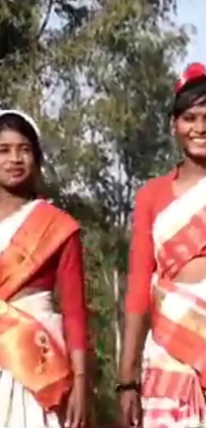 Women in colorful traditional attire in a natural setting.