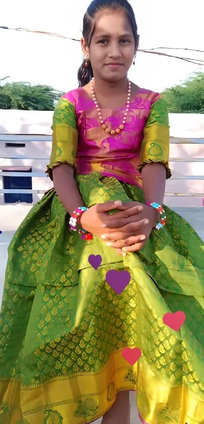 Person in vibrant traditional dress with scenic background.