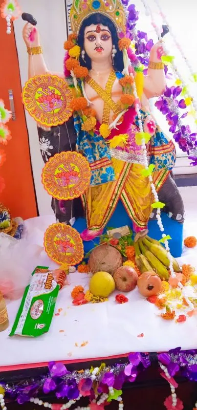 Vibrant idol decorated with colorful garlands and fruits for a festival celebration.