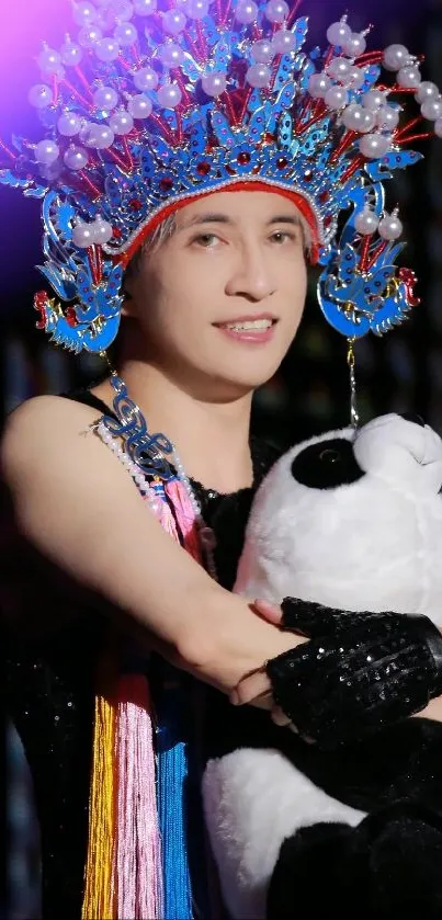 Performer in vibrant traditional attire holding a panda, against a colorful background.