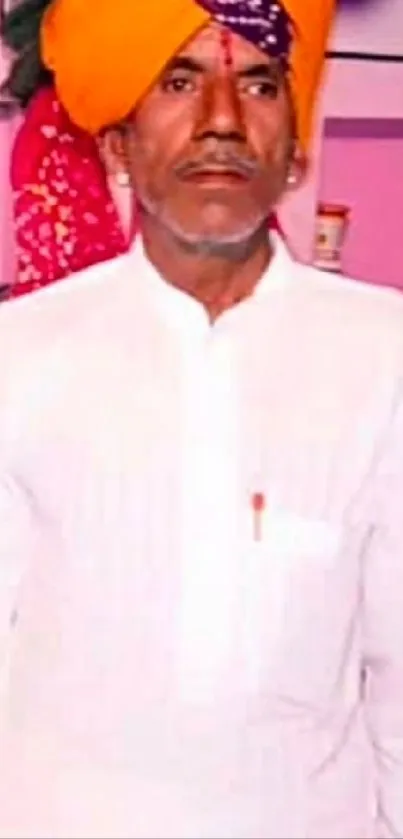 Man in traditional attire with colorful turban.