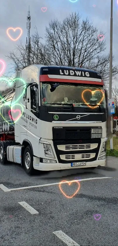 Truck on road with colorful heart decorations.