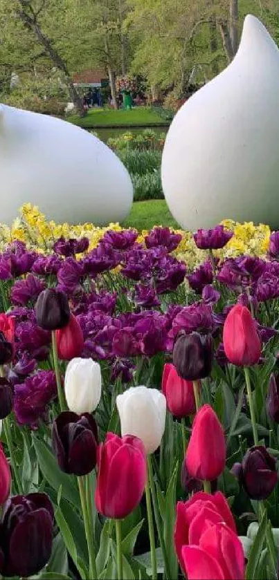 A vibrant tulip garden with colorful blossoms and serene sculptures.