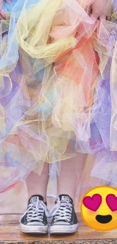 Colorful tulle dress and black sneakers on a wooden platform.