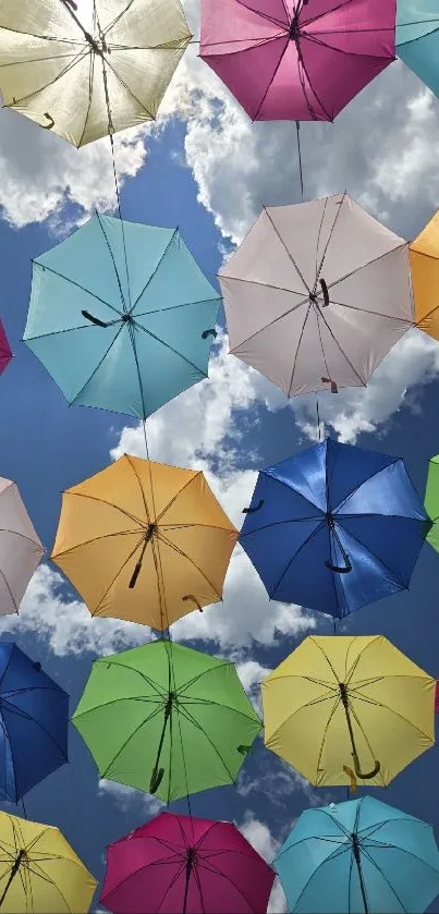 Sky filled with colorful hanging umbrellas against clouds.