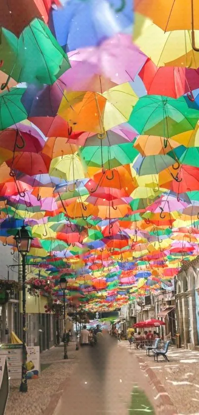 Colorful umbrellas suspended above a lively street scene.