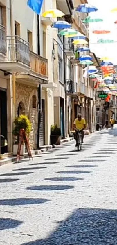 Charming street with colorful umbrellas hanging overhead.