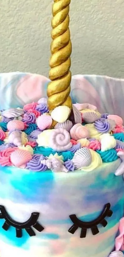 Colorful unicorn cake with a golden horn and pastel icing.