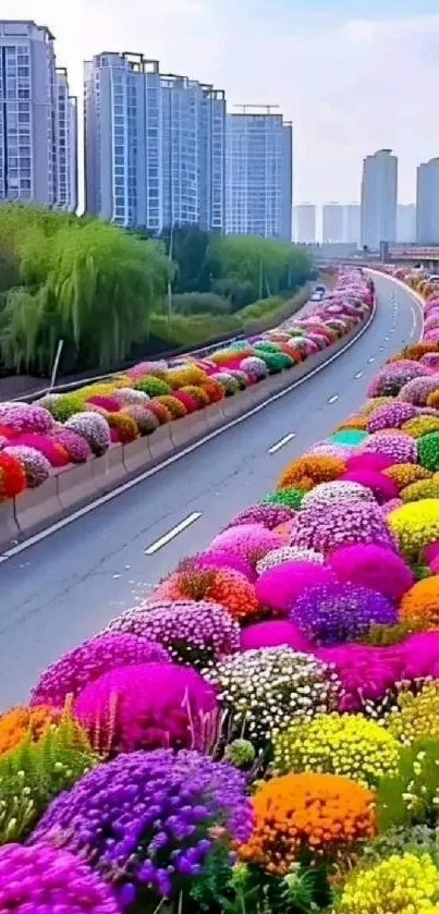 Highway bordered with colorful flowers and city buildings.