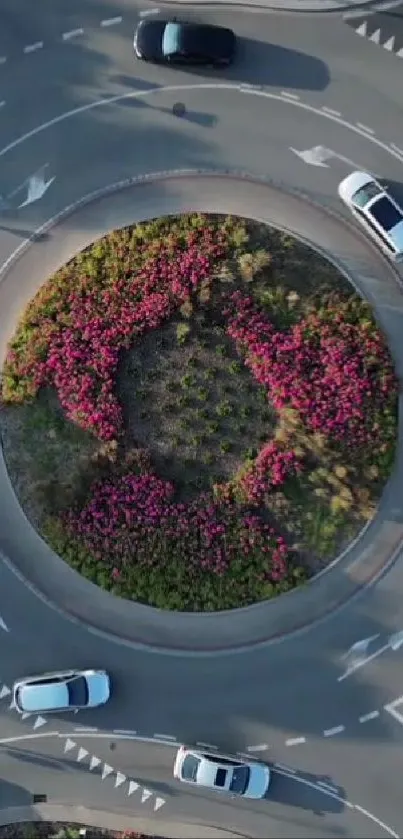 Aerial view of an urban roundabout with colorful flowers.