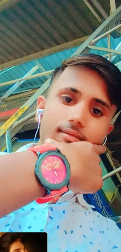 A colorful selfie with pink watch in an urban industrial setting.