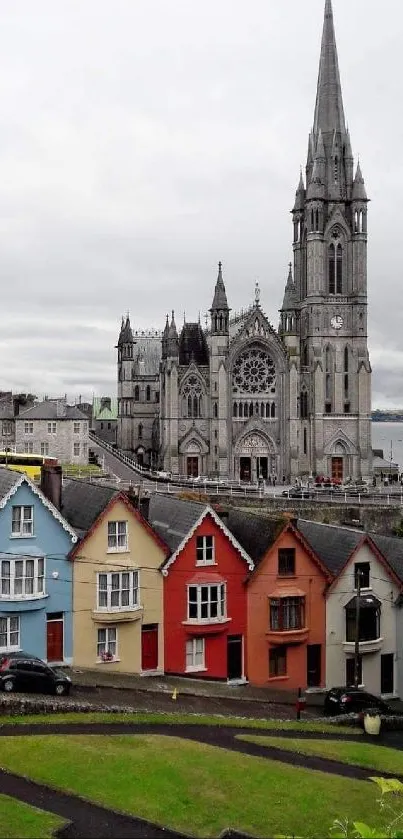 Colorful village with a gothic cathedral backdrop.