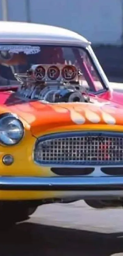 Colorful vintage race car with flames at high speed on track.