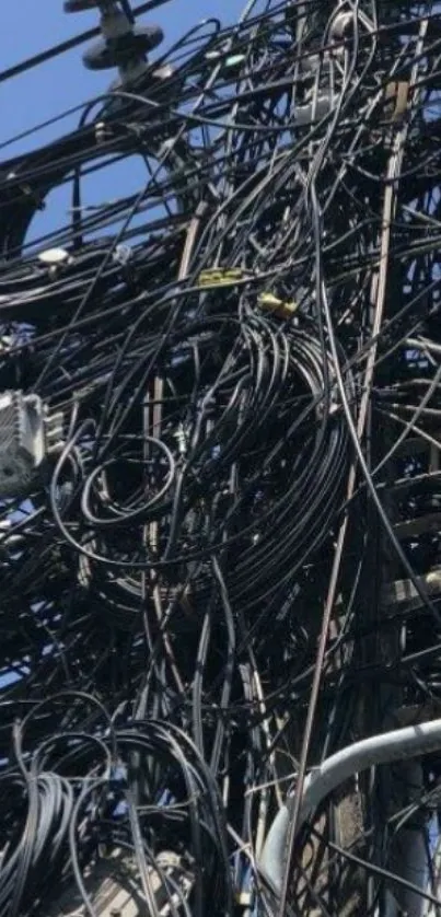 Intricate electrical wires against the blue sky.