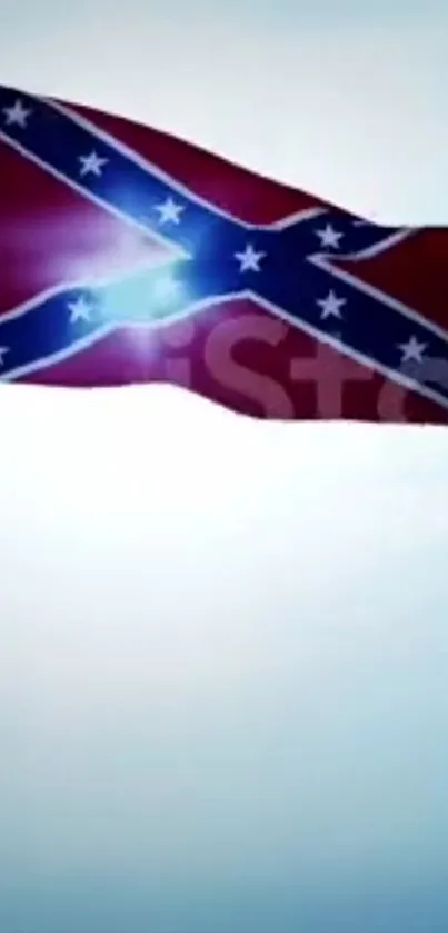 Confederate flag waving against blue sky.