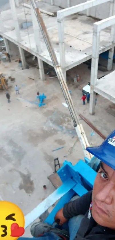 Worker taking a selfie on a construction site at high altitude.