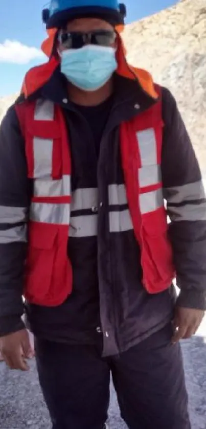 Construction worker in safety gear at a quarry site.