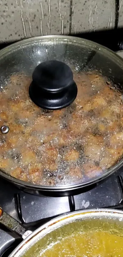 Glass pan cooking on stove with steam visible.