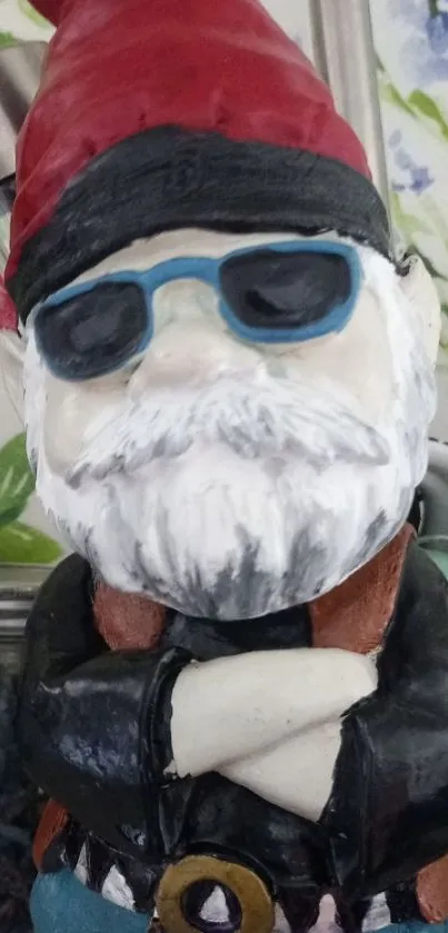 Trendy gnome statue with sunglasses and a red hat against a leafy background.