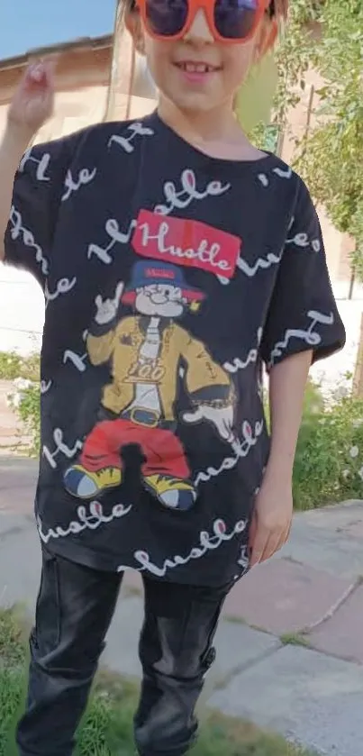 Child in stylish cartoon shirt outdoors.