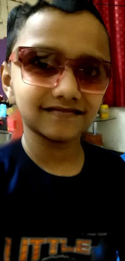 A young child in sunglasses with a stylish look.