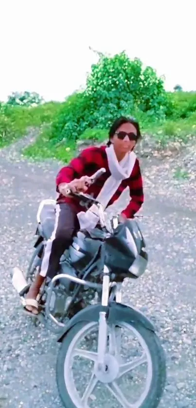 A person riding a motorcycle on gravel with green background.