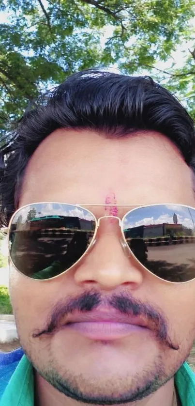 Cool selfie with sunglasses reflection and green background.