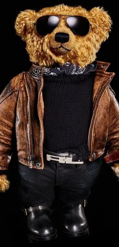 Stylish teddy bear in a leather jacket and sunglasses on a black background.