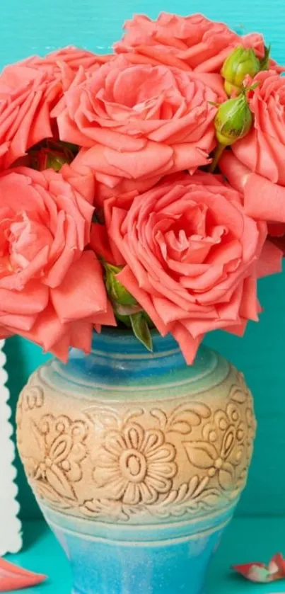 Beautiful coral roses in a decorative vase against a turquoise background.