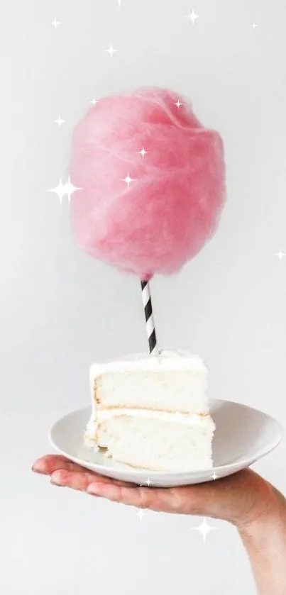 Pink cotton candy above a white cake slice on a plate.