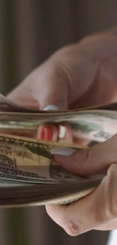 Close-up of hands counting U.S. dollar bills.