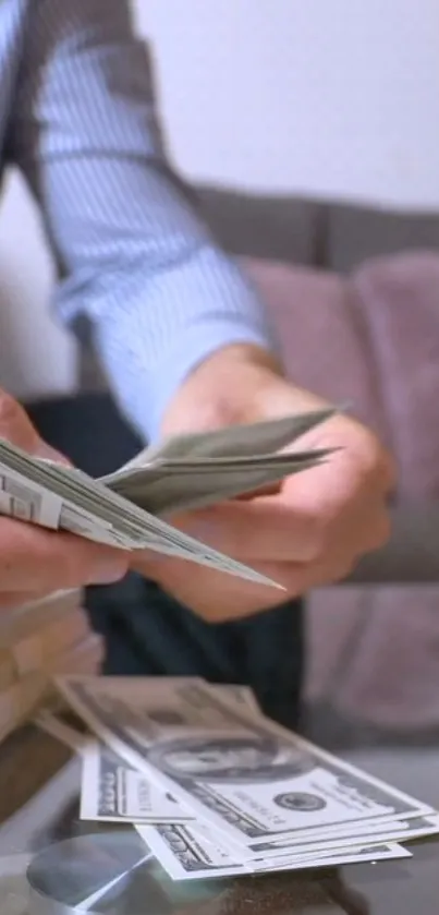 Person counting money at a table.