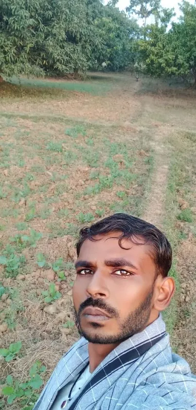 Countryside selfie with lush green landscape in the background.