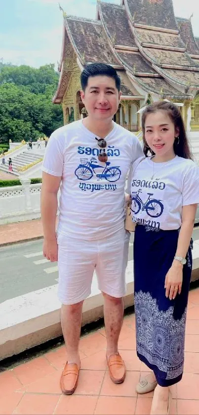 Couple in matching outfits at a historic temple.