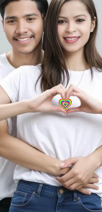 Couple forming a colorful heart symbol with hands.