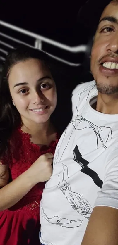 Couple taking an evening selfie on a rooftop.