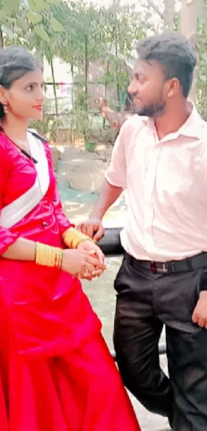 Couple in garden with red dress.