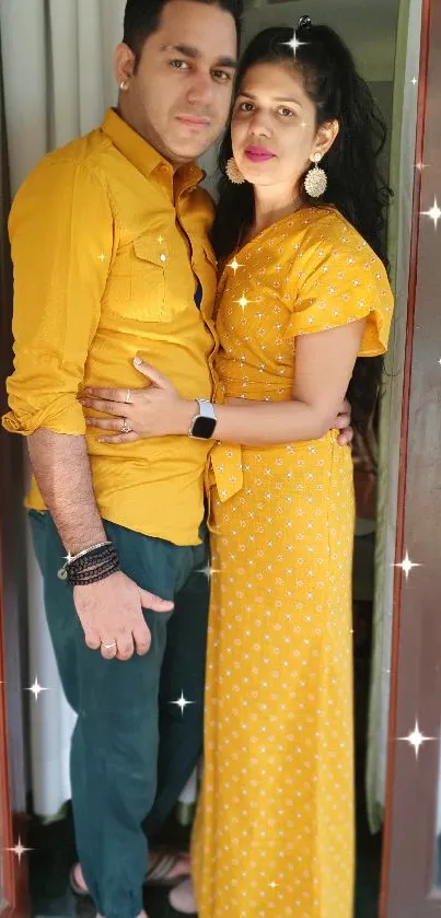 Couple in matching yellow outfits by a window.