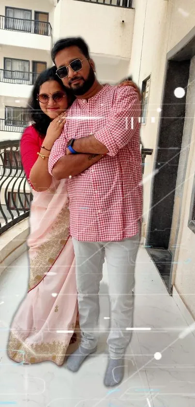 Couple in traditional attire on a balcony.