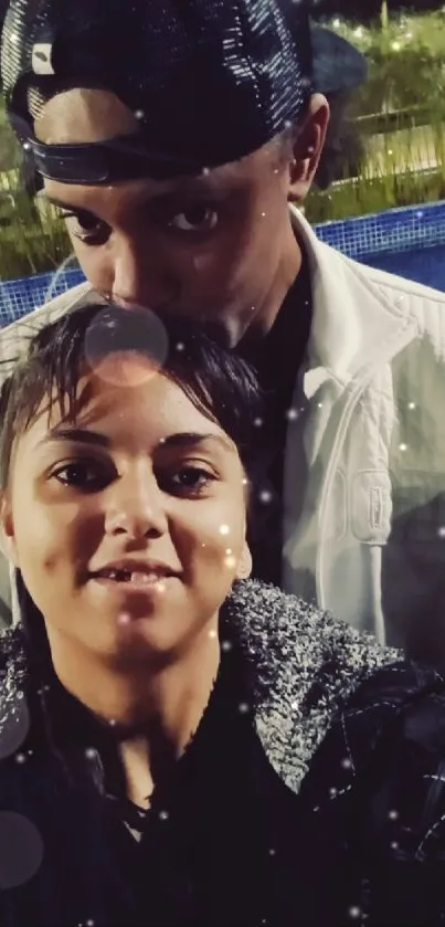 Romantic couple selfie outdoors at night.