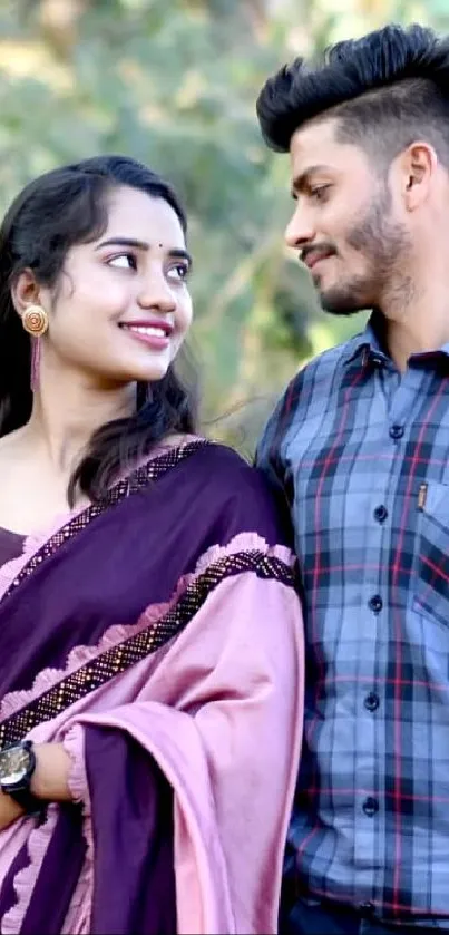 Couple smiling at each other in nature.