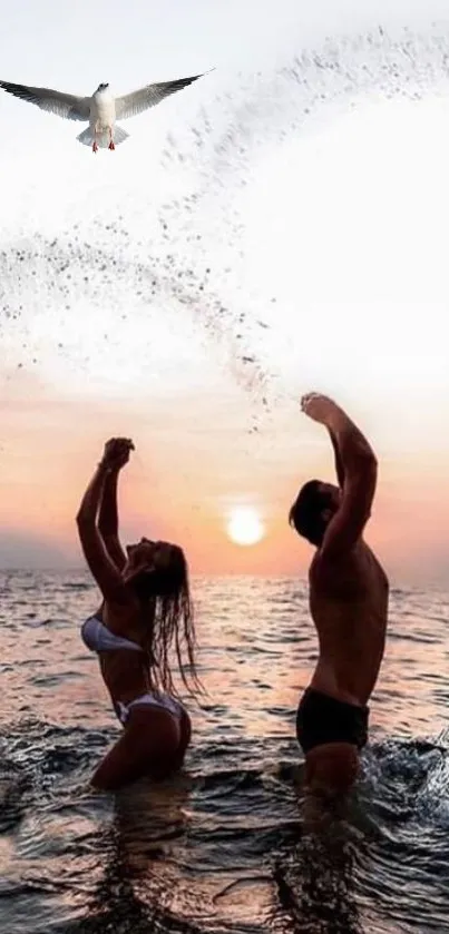 Couple enjoying sunset on the beach with water splashes and a flying bird overhead.