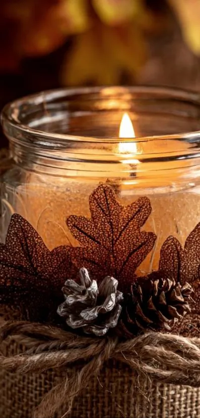 Cozy autumn candle with rustic decor in a jar.