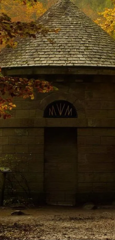 Stone cabin in autumn forest with vibrant foliage.