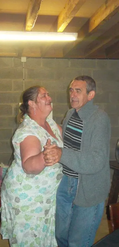 Two people dancing in a cozy basement setting.