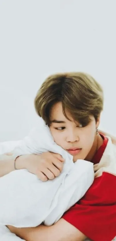 Cozy boy in red shirt on a light gray background.