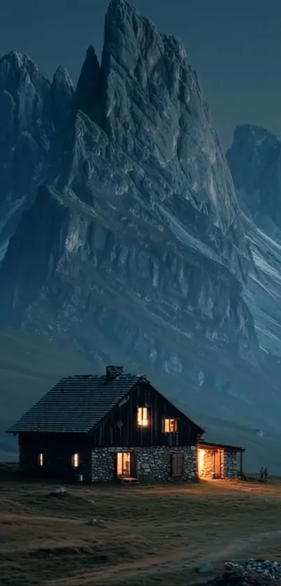 Cozy cabin at night with mountain backdrop.